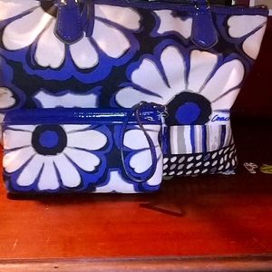 A flowered coach purse the colors are blue black an white